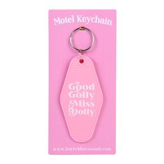 a pink keychain with the words good, golly miss dolly on it