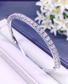 A gorgeous and huge high-end luxury fine earth mined natural WHITE diamonds, in MODERN STYLE, bangle handmade from solid 18K White gold.  This elegant and oh so pretty bangle is a timeless piece and is in BRAND NEW condition. With 27 pieces of large diamond, TOP sparkling, and CLEAN quality. And wraps the wrist perfectly. It is so excellently made and feels so lovely on, you forget you are wearing it - until someone reminds you, it certainly gets A LOT OF ATTENTIONS! The bangle contains 27 round Luxury Platinum Bangle With Diamond Accents, Diamond Bangle For Anniversary, Exquisite Platinum Bracelet In Diamond White, Platinum Bangle Diamond Bracelet, Platinum Bangle Diamond Bracelet With Diamond Cut, Platinum Diamond Cut Bangle Bracelet, Luxury Platinum Tennis Bracelet, Formal Platinum Bangle With Brilliant Cut, White Platinum Diamond Bracelet, Fine Jewelry