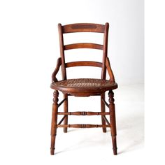 an old wooden chair with leather seat and backrests on a white background,