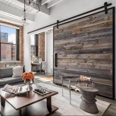 a living room filled with furniture and a sliding door in front of a large window