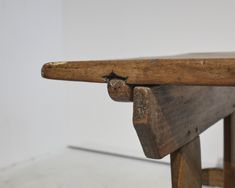 an old wooden bench with no one sitting on it's back legs or feet