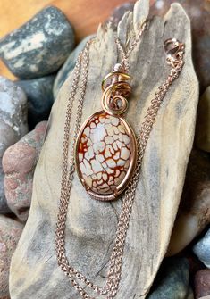 "Dragon vein agate pendant with antique copper, silver, and rose gold wire wrap Comes with 18\" chain shown in photos. Pendant measures 1-5/8\" x 3/4\"" Wire Wrapped Round Agate Jewelry, Wire Wrapped Agate Pendant Jewelry, Hand Wrapped Agate Pendant Jewelry, Handmade Jasper Oval Necklaces, Handmade Jasper Oval Necklace, Handmade Oval Jasper Necklaces, Handmade Oval Jasper Necklace, Unique Hand Wrapped Oval Pendant Jewelry, Wire Wrapped Ocean Jasper Pendant Jewelry