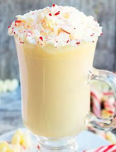 a cup of hot chocolate with whipped cream and candy canes