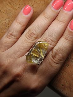 Make a statement and give the gift of clarity with our Rutilated Quartz Ring. This exquisite piece showcases the unique beauty of rutilated quartz, known for its delicate golden needles and powerful energy. It's more than a statement piece; it's a meaningful gift that captures the essence of insight and elegance. 🔸Adjustable band ring 🔸25 mm stone size 🔸Color may vary according to lighting 🔸Silver filled We offer  🔸The exact item as in the picture  🔸Fast shipping  🔸Free shipping for eligi Unique Clear Crystal Ring As A Gift, Unique Clear Crystal Ring For Gift, Gemstone Rings Suitable For Gift, Clear Gemstone Ring As Gift, Clear Gemstone Rings For Gift, Quartz Jewelry Ring Gift, Quartz Ring Jewelry For Gift, Quartz Crystal Ring With Gemstone For Gift, Quartz Crystal Ring As A Gift