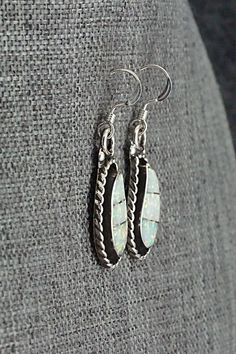 These opalite and sterling silver inlay earrings were made by Zuni silversmith Susie Lowsayatee. The back is signed SL and Zuni.Height: 1 3/8"Width: 1/2"Free shipping on all orders! We ship with USPS and always include tracking. All orders ship within a day of payment.Returns are accepted up to 30 days after you receive your order. Just send us a message. Our shop offers cash back or store credit. The item must be returned in new condition. Handmade Opal Earrings In Silver, Silver Opal Dangle Earrings, Silver Dangle Opal Earrings, Sterling Silver Jewelry With White Inlay, White Sterling Silver Jewelry With Inlay, Artisan Silver Opal Jewelry, Unique Silver Earrings With Inlay, Sterling Silver Inlay Earrings, Southwestern Silver Earrings With Inlay