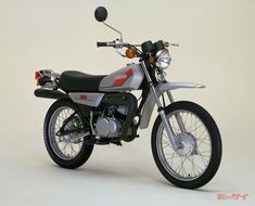 a silver and black motorcycle parked on top of a white floor