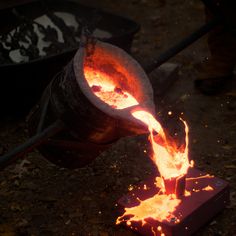 a piece of metal that is on some kind of device with fire coming out of it