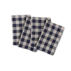 three black and white checkered napkins sitting on top of each other