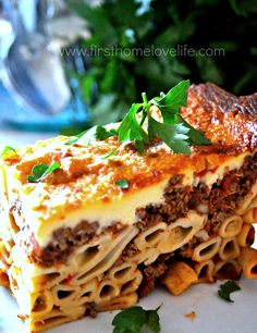 a close up of a plate of food with the words greek style lasagna pasta