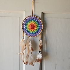 a colorful dream catcher hanging on a door