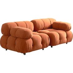 an orange couch sitting on top of a white floor