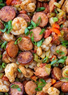 a plate full of shrimp, sausage and vegetables