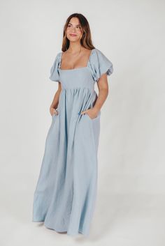 Join us in welcoming the *breathtaking* Candace Maxi Dress to the Worth Collective repertoire - we know you're going to love her! This pastel-hued, 100% linen dress is the epitome of elegance and luxury. Its beautiful neckline frames your decolletage, while the gently puffed sleeves and full skirt accent this gown's exquisite craftmanship. It's the perfect choice for this season's weddings, photo shoots, and other special events! FIT: Runs true to size. Empire waist and smocked bodice will accom Fitted Blue Linen Dress, Blue Fitted Linen Midi Dress, Chic Blue Linen Maxi Dress, Fitted Linen Maxi Dress For Spring, Fitted Blue Linen Dress For Daywear, Blue Maxi Linen Dress, Blue Linen Maxi Dress, Worth Collective, Athleisure Tops