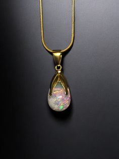 This is a beautiful Australian opal necklace. This necklace is made using a 14x11mm Crystal clear tear drop filled with  Australian opals and high quality lab grown kyocera opals for extra fire color then capped with a beautiful leaf design! Opals float freely like a miniature snow globe! The 18.5inch gold plated snake chain is included and easily swappable! -Australian Opals -Fire kyocera opals -18.5inch goldp chain Any questions please contact through ETSY! Luxury Artisan Opal Necklaces, Formal Teardrop Cabochon Necklace, Opal Teardrop Gemstone Necklace, Opal Drop Gemstone Jewelry, Teardrop Opal Gemstone Necklaces, Opal Teardrop Pendant Necklace With Gemstone, Teardrop Opal Necklace With Gemstone, Formal Opal Teardrop Pendant Jewelry, Formal Teardrop Opal Pendant Jewelry