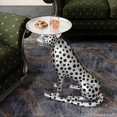 a dalmatian dog with a plate on it's head sitting in front of a couch