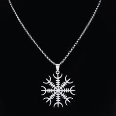 a snowflake pendant is shown on a black background