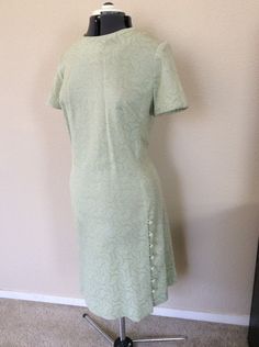 Vintage green and gold dress with button details down the left side. Full coverage zipper back. No size tag on this one- Dress appears to be a vintage 10 or 12, I will post measurements soon. Please see photos for a couple of barely noticeable spots that I didn't notice until I took these photos. Green Vintage A-line Midi Dress, Vintage Green A-line Midi Dress, Green A-line Vintage Midi Dress, Light Green Fitted Dress With Short Sleeves, Fitted Formal Dress With Side Buttons, Vintage Fitted Green Dress, Vintage Green Midi Length Dress, Green Fitted Vintage Dress, Vintage Green Midi Dress For Formal Occasions