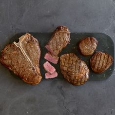 steaks and potatoes on a slate platter