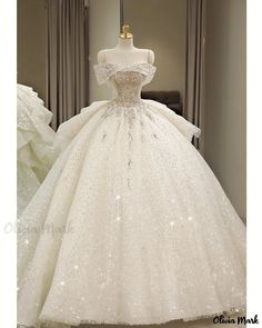 a white ball gown with sequins on the skirt