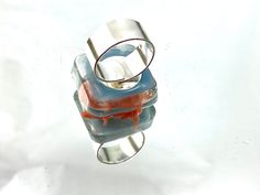 "I created this original ring using a tiny pig, that I made \"fly\" and sealed in hand cast resin. I have left the sides open a bit so you can view from all sides. It has the look of glass but will not break and is waterproof. It does sit higher, but there is nothing sharp to snag. The band is .999 fine silver plate. It has a hidden adjustable band that will best fit a size 6 to 8 1/2\". It is just over 1\" x 1\" and shown on my size 8 finger. It sits nicely on the hand and does not turn if snug Tiny Pigs, Flying Pig, Resin Ring, Hand Cast, Fine Silver, Silver Plate, Statement Rings, Silver Rings, Turn Ons