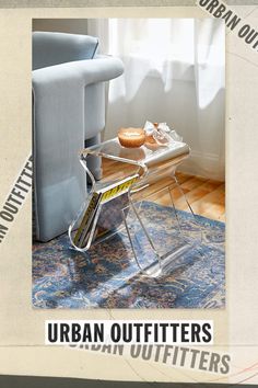 a magazine rack sitting on top of a blue rug next to a chair and window