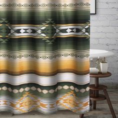 a shower curtain with an abstract design in green, yellow and brown colors on it