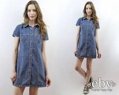 Vintage nineties DENIM MINI DRESS. Snap buttons up front. Chest pockets. 100% cotton. Classic wardrobe staple. Model is 5'9. Her measurements are: bust=34 inches, waist=26 inches, & hips=34 inches. The dress fits as shown on her. We measure on a flat surface from seam to seam. Bust, waist, & hip measurements have already been doubled. We suggest you compare our measurements to a garment you already own and know fits you well to ensure a proper fit. label: gap approximate size: S vintage size on tag: 8 material: 100% cotton across shoulders: 14.75 inches arm length: 6.25 inches bust: 34 inches waist: 31 inches hips: 34 inches length: 32.5 inches VERY IMPORTANT WE DO NOT TAKE RETURNS FOR ITEMS THAT DO NOT FIT. We take extreme care to measure each item accurately, so please take note of the m Vintage Cotton Denim Mini Dress, Vintage Denim Blue Denim Dress With Pockets, Retro Cotton Denim Dress With Pockets, Vintage Medium Wash Denim Dress With Pockets, Retro Buttoned Denim Dress For Spring, Vintage Denim Button-up Dress, Vintage Mini Length Denim Dress, Vintage Denim Dress With Short Sleeves, Retro Denim Dress With Buttons For Spring