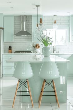 two white chairs sitting at a kitchen island