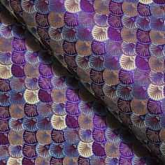 purple and gold patterned fabric with small circles on the top, in different colors or shapes