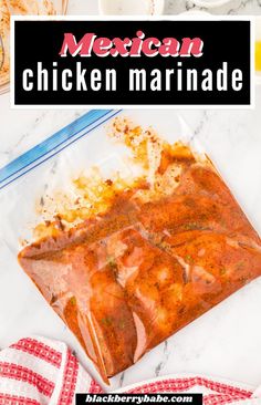 mexican chicken marinade in a clear bag on a marble countertop with red and white checkered napkins