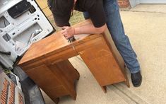 a man working on a piece of furniture