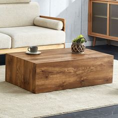 a wooden coffee table sitting on top of a rug