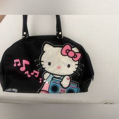 Big Pink Hello Kitty X Duffle Bag Purse !!! Pink Like Satin Material In The Inside And Is Very Very , Very Spacious And Wide. Opens All The Way Up ! And Has Multiple Pockets Inside And Places To Put Ur Cards/Money/ Phone And There’s Also A Pocket That Zips Open And Closed Too To Put Stuff In Like Ur Makeup , Etc ! . You Can Fit A Lot In This Bag And It’s Also Sooo Cute. Travel Bag / Tote Bag/ Purse /Duffle Bag ! Good Condition. See Pics.. Maybe Need To To Be Cleaned A Little But It’s Nice And Th Trendy Black Bag With Hello Kitty Print, Black Hello Kitty Print Bag For Daily Use, Black Hello Kitty Print Travel Bag, Black Hello Kitty Travel Bag, Cute Black Bag With Hello Kitty Print, Room Y2k, Money Phone, Hello Kitty Bag, Purse Pink