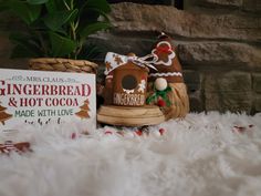 a gingerbread and hot cocoa sign next to a basket with christmas decorations on it