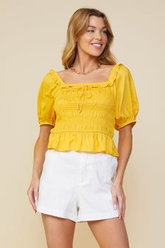 Here comes the sun. Done in a golden yellow shade, this lightweight jacquard top features a smocked bodice, short sleeves, and a ruffle-trimmed square neckline with metal-tipped tie detailing. •Square neckline  •Ruffle trim  •Metal-tipped tie detail  •Short sleeves  •Smocked bodice  Item Number: 44681 Summer Puff Sleeve Top With Ruffles And Square Neck, Fitted Smocked Top With Gathered Square Neckline, Fitted Smocked Top With Square Neck And Gathered Neckline, Summer Puff Sleeve Top With Smocked Bodice, Summer Smocked Bodice Puff Sleeve Top, Summer Short Sleeve Puff Top With Smocked Back, Fitted Smocked Top With Gathered Neckline For Summer, Spring Smocked Top With Gathered Neckline And Short Sleeves, Spring Smocked Top With Puff Sleeves And Gathered Neckline