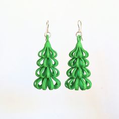 This is a pair of 3D printed earrings in lightweight nylon plastic.   The highly textured surface looks like pieces of softly folded ribbon assembled to look like a tree.    They were hand dyed to achieve the green color. Their light weight means that they will have lots of eye-catching movement when you wear them. Being a green color, these earrings would make a nice accessory for Christmas.  They look sort of Christmas-y but don't scream Christmas, if you know what I mean.  Earring hooks:  Sterling silver Jump rings:  Silver plated brass Please note that due to the nature of hand dyeing, the color of your earrings might not match exactly the color shown in the photo. 3d Printed Christmas Earrings, 3d Printed Christmas Gifts, 3d Print Shop, Scream Christmas, 3d Printed Christmas, 3d Printed Earrings, Printed Earrings, 3d Printing Art, 3d Printed Jewelry