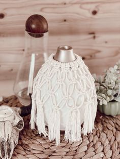 a white vase sitting on top of a woven basket