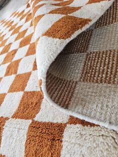 an orange and white checkered rug on the floor