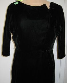 "I bought this lovely black velvet dress with the intention of redesigning it, or up-cycling it. This is made from the beautiful soft rayon velvet that I love so much. I would date the era of this dress to be 50s-60's close to the Jackie O Era. Although the original price tag is still on this dress, it has some flaws. So who knows what happened? The neckline has a bit of wire where it goes into a V. Maybe to bend or shape the area? The waistline and the area on the neck, has little scuffmarks as if there was something there at some point? The weirdest thing of all is how the armpit is torn and sewn back (terrible sew job). Although the armpits have gussets, they ended up tearing anyway. If you are a handy sewer you could make larger gussets and replace the area where there are tears, or ke Vintage Fitted Velvet Dress, Fitted Vintage Velvet Dress, Vintage Black Velvet Party Dress, Vintage Black Velvet Dress For Party, Vintage Black Velvet Dress For Evening, Vintage Velvet Cocktail Dress, Jackie O, Black Velvet Dress, Who Knows