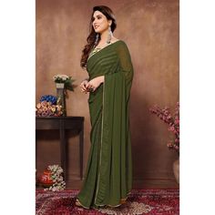 Green colored saree is made from georgette fabric which is highlighted with weaving checks & lace border work as shown with pleats are stitched and size adjusted belt. comes along with printed banglori silk blouse which you can customise as per your design/style. Occasion - You can wear this saree for parties, functions and events. Note:- the actual product may differ slightly in color and design from the one illustrated in the images when compared with computer or mobile screen. Measurements: S Green Georgette Saree, Colorful Blouse, Colorful Blouses, Mobile Screen, Georgette Saree, Georgette Fabric, Lace Border, Georgette Sarees, Design Style