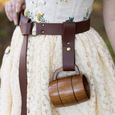 Always have your drink close by when you add this mug holder to your costume belt. Easily remove and put your cup back into place with a metal snap which closes around your mug handle. Made with 100% vegan leather and a metal snap. Perfect for adding to a belt on your renaissance faire, medieval, viking, cosplay, or LARP costume.The color of the mug strap may vary slightly from these photos and our other accessories as we transition to new materials. Viking Cosplay, Mug Handle, Linda Smith, Mug Holder, Larp Costume, Belt Pouch, Larp, Running Women, Slow Fashion