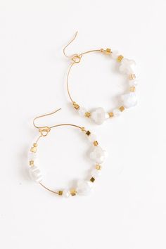 - Fall head over heels for these chic earrings! - Gold colored metal material - Dangling hoops - Shimmering clover shaped beading with gold accent beads - Hook backs - Size: 2 inches White Metal Hoop Jewelry, White Metal Beaded Earrings With Ear Wire, Adjustable White Hoop Earrings With Ear Wire, White Metal Beaded Earrings, White Small Hoop Beaded Earrings Nickel Free, White Metal Dangle Hoop Earrings, Nickel-free White Hoop Earrings, Adjustable Nickel-free White Hoop Earrings, White Beaded Metal Earrings