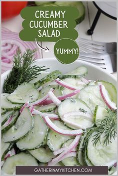 a white bowl filled with cucumber salad next to sliced onions and dill