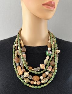 One-of-a-kind multi-strand statement necklace. Handcrafted in Scottsdale, Arizona. Beads: 5 strands of Carved Bone and Jade, Ceramic, Vintage Glass, Wood and Brass. Dimensions: approximately 26" + 3" extender. Make a Statement with this interesting mixture of nature and craftsmanship! Free Shipping Refund Policy Green Multi-strand Hand-strung Necklaces, Multi-strand Wooden Beads For Jewelry Making, Unique Hand-strung Multi-strand Necklace, Artisan Multi-strand Jewelry With Spacer Beads, Unique Multi-strand Jewelry With Spacer Beads, Green Multi-strand Hand-strung Beaded Necklaces, Unique Multi-strand Necklaces With Spacer Beads, Unique Multi-strand Necklace With Spacer Beads, Green Multi-strand Wooden Beads Jewelry