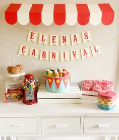 a carnival themed dessert table with cupcakes and candy