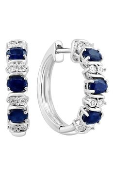 Easy-to-wear hoop earrings will add significant polish to even your most casual ensembles. Total sapphire weight: 1.62ct. Total diamond weight: 0.07ct. Color: H–I Clarity: I2 Sterling silver/sapphire/diamond Made in the USA Diamond Guide Blue Round Hoop Earrings For Anniversary, Blue Hoop Earrings With Prong Setting For Anniversary, Blue Hoop Earrings With Prong Setting, Blue Diamond Round Hoop Earrings, Blue Diamond Hoop Earrings, Blue Diamond Hoop Earrings Fine Jewelry, Anniversary Sapphire Hoop Earrings, Blue Small Hoop Earrings For Anniversary, Diamond Guide