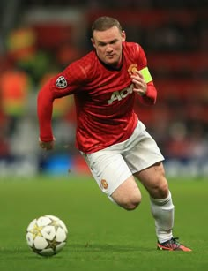 a man running with a soccer ball on a field