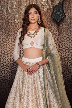 Ivory can can attached lehenga with all over embroidered floral jaal motifs with sequin work. Comes with padded cut-out blouse and dupatta.
Components: 3
Pattern: Embroidered
Type Of Work: Sequin,Thread
Neckline: Round
Sleeve Type: Three quarter
Fabric: Raw silk
Color: Ivory
Other Details: 
Length: Lehenga: 44 inches
Model Height: 5ft 8inches wearing size XS
Closure: Blouse: Back hook, zip
Note: Neckpiece worn by the model is not for sale
Occasion: Sangeet,Cocktail - Aza Fashions Embroidered Silk, Color Ivory, Raw Silk, Set For Women, Indian Wear, Aza Fashion, Model Height, Sleeve Type, Three Quarter