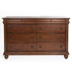 a wooden dresser with many drawers and knobs on the bottom drawer, against a white background