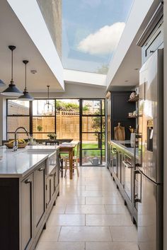 an open kitchen and dining area with skylights